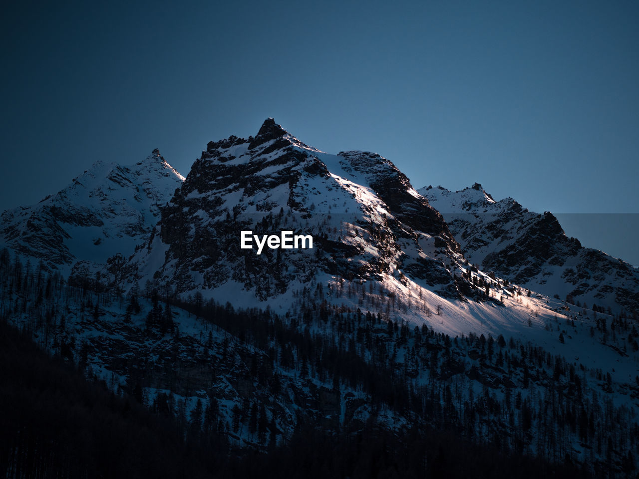 Scenic view of snowcapped mountains against sky. amazing light during the sunset in the italian alps