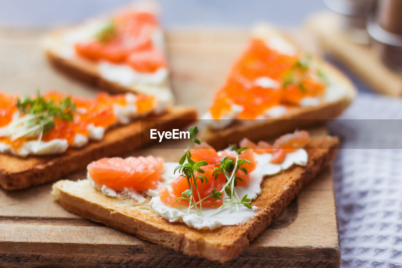 Sandwiches or tapas of bread red caviar and red fish with micro greens, seafood luxury delicacy 