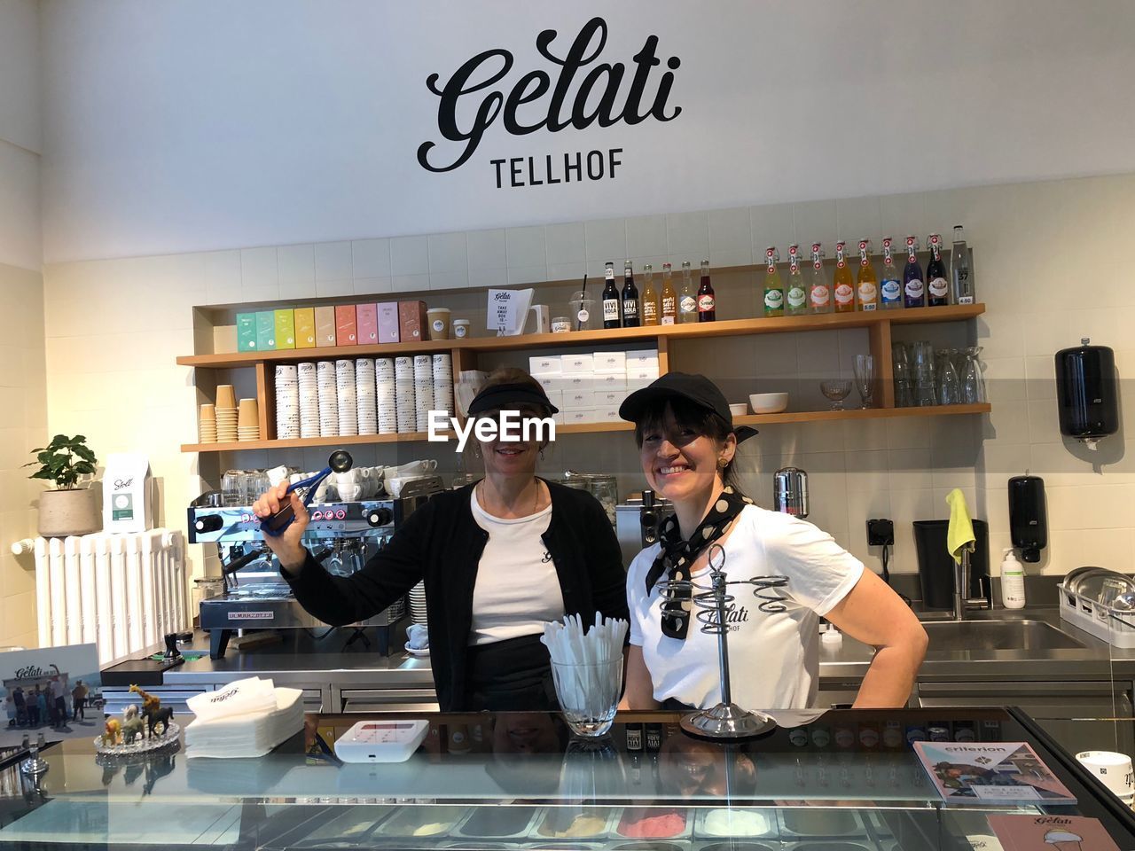 Portrait of smiling baristas standing at store
