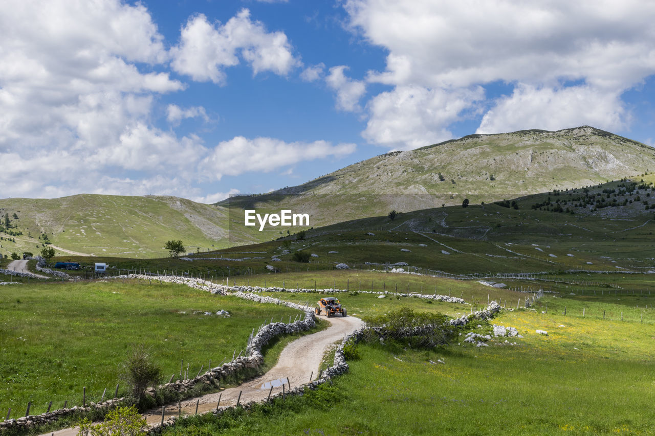 Scenic view of green landscape against sky