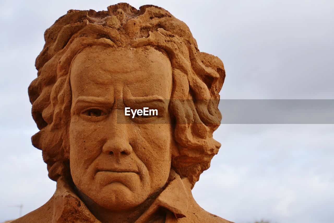 CLOSE-UP OF A STATUE AGAINST SKY