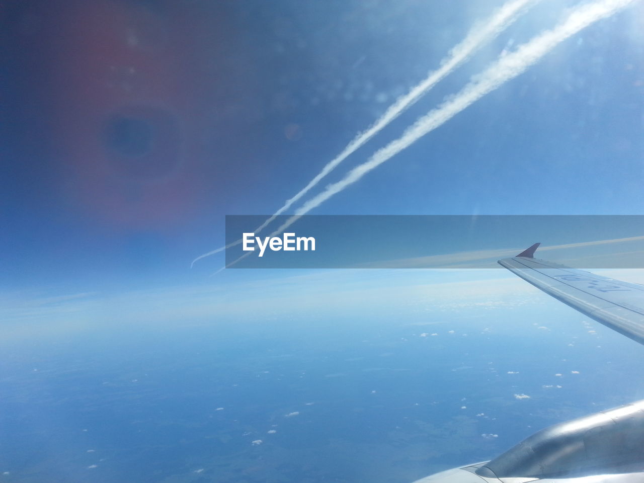 CROPPED IMAGE OF AIRPLANE OVER SEA