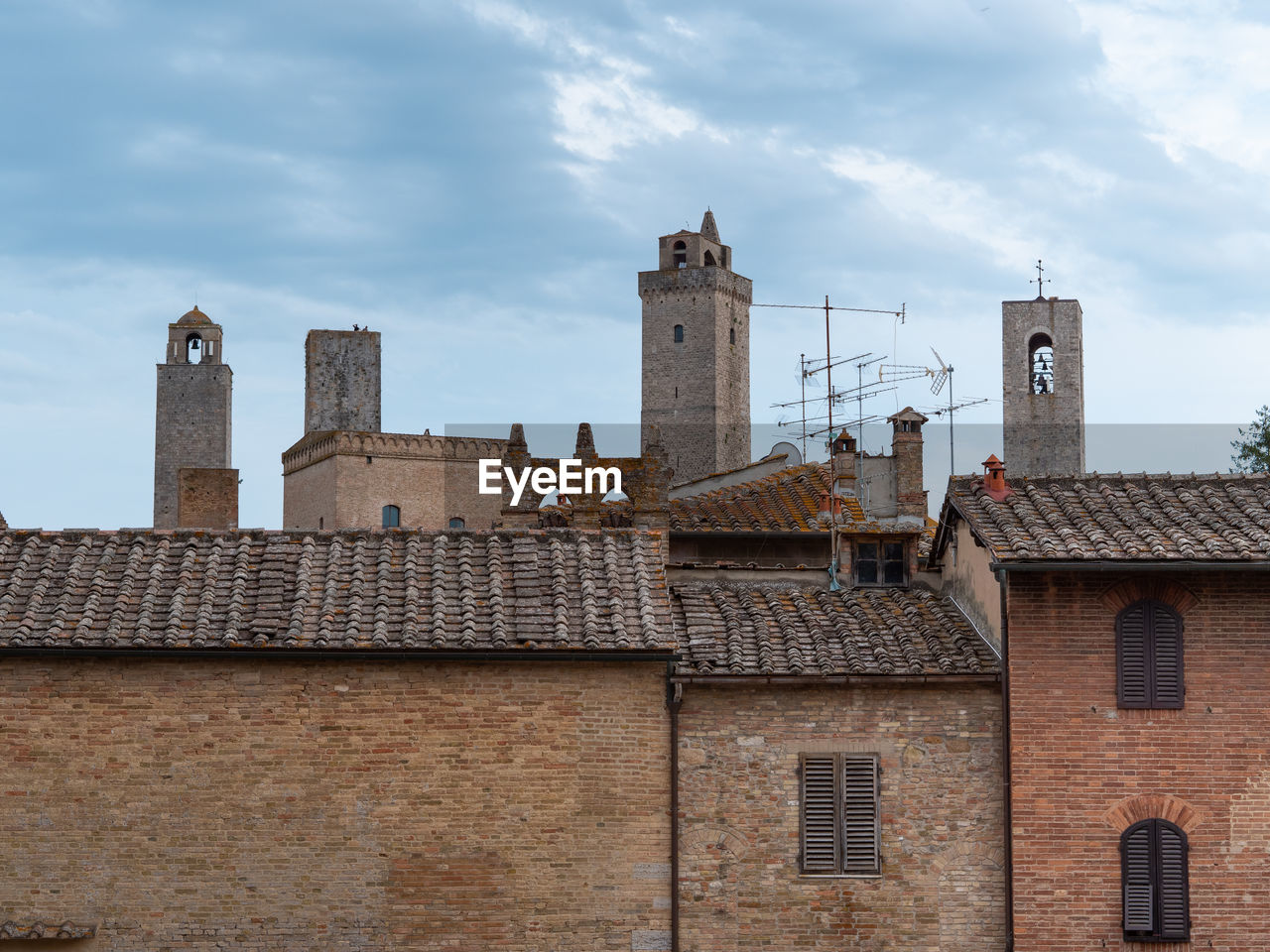 Details of bell towers and brick houses in san gimignano in tuscany, siena - italy.