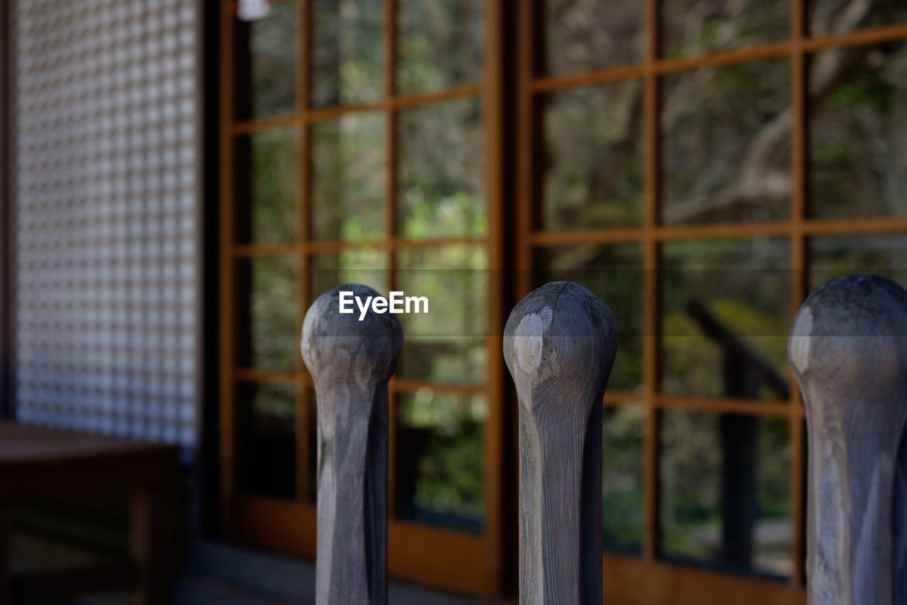 Close-up of wooden bollard against temple