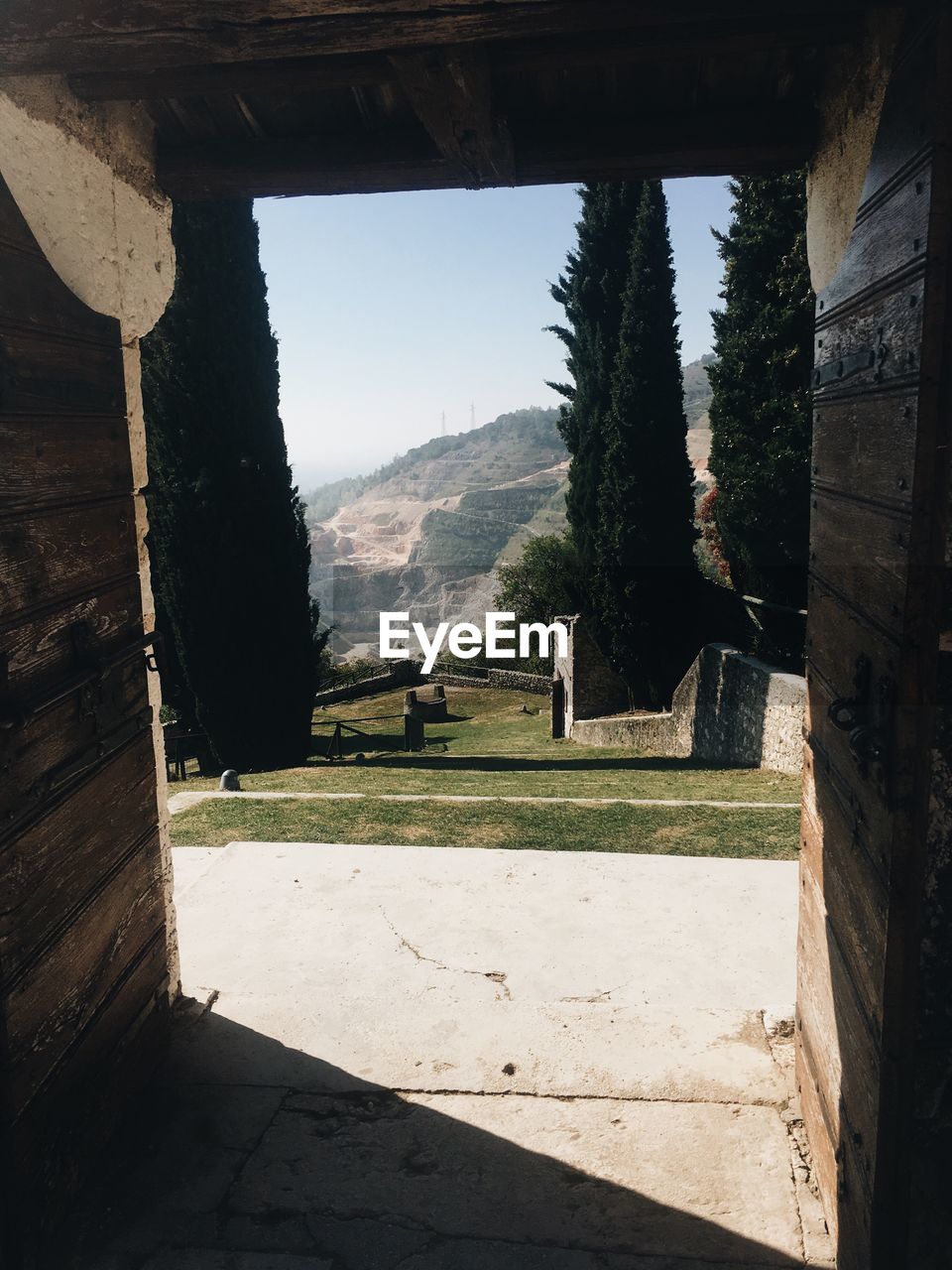 SCENIC VIEW OF MOUNTAINS SEEN THROUGH WINDOW