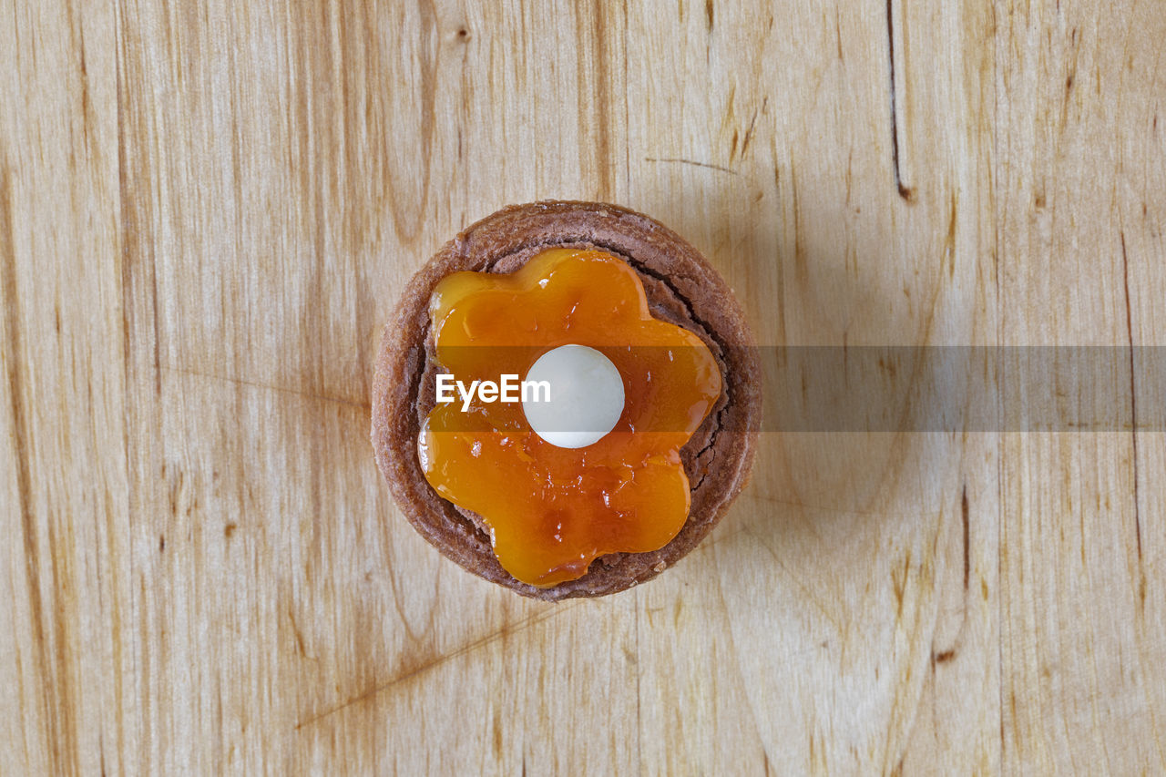 food and drink, food, wood, freshness, table, healthy eating, directly above, wellbeing, egg, egg yolk, indoors, yellow, no people, produce, still life, high angle view, close-up, brown, sweet food