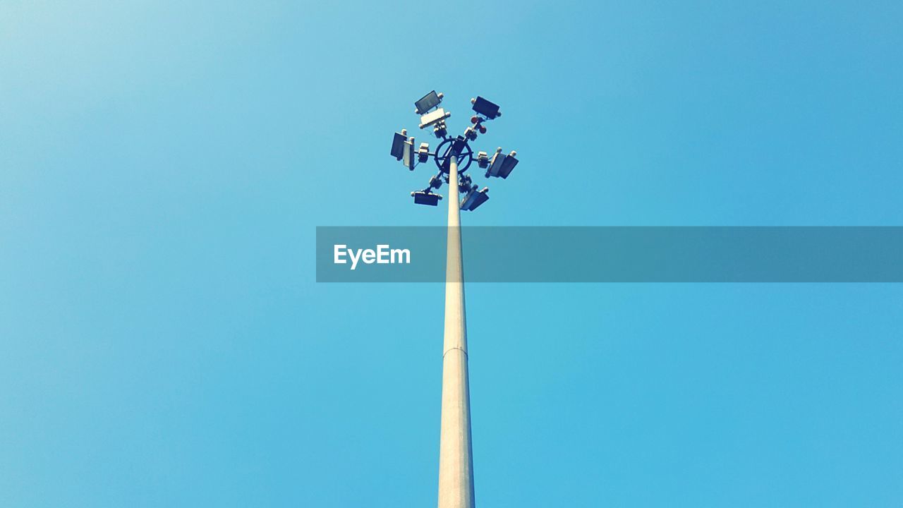 Low angle view of floodlight against clear blue sky