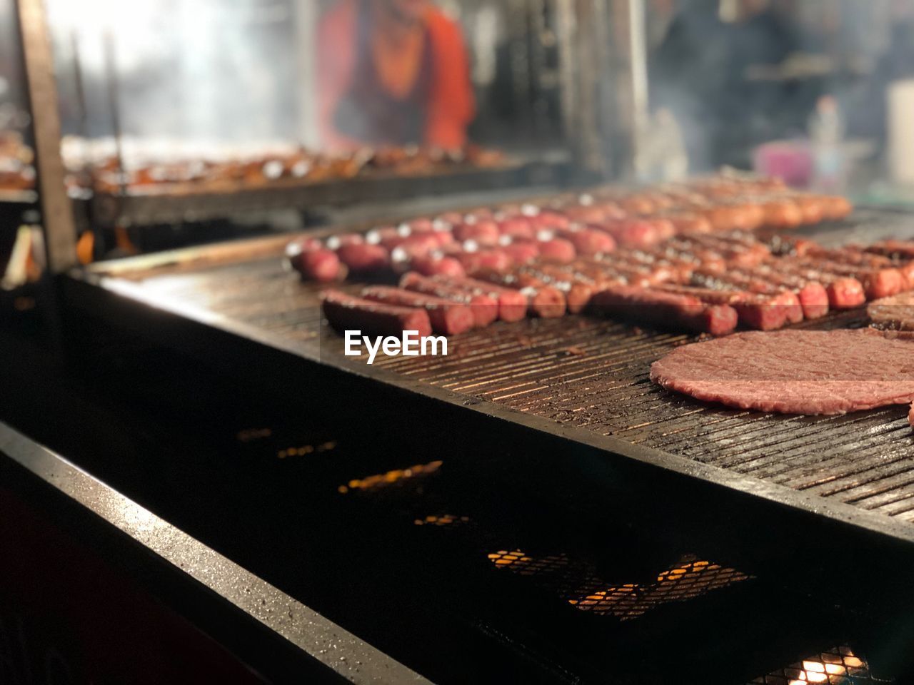 CLOSE-UP OF MEAT ON GRILL