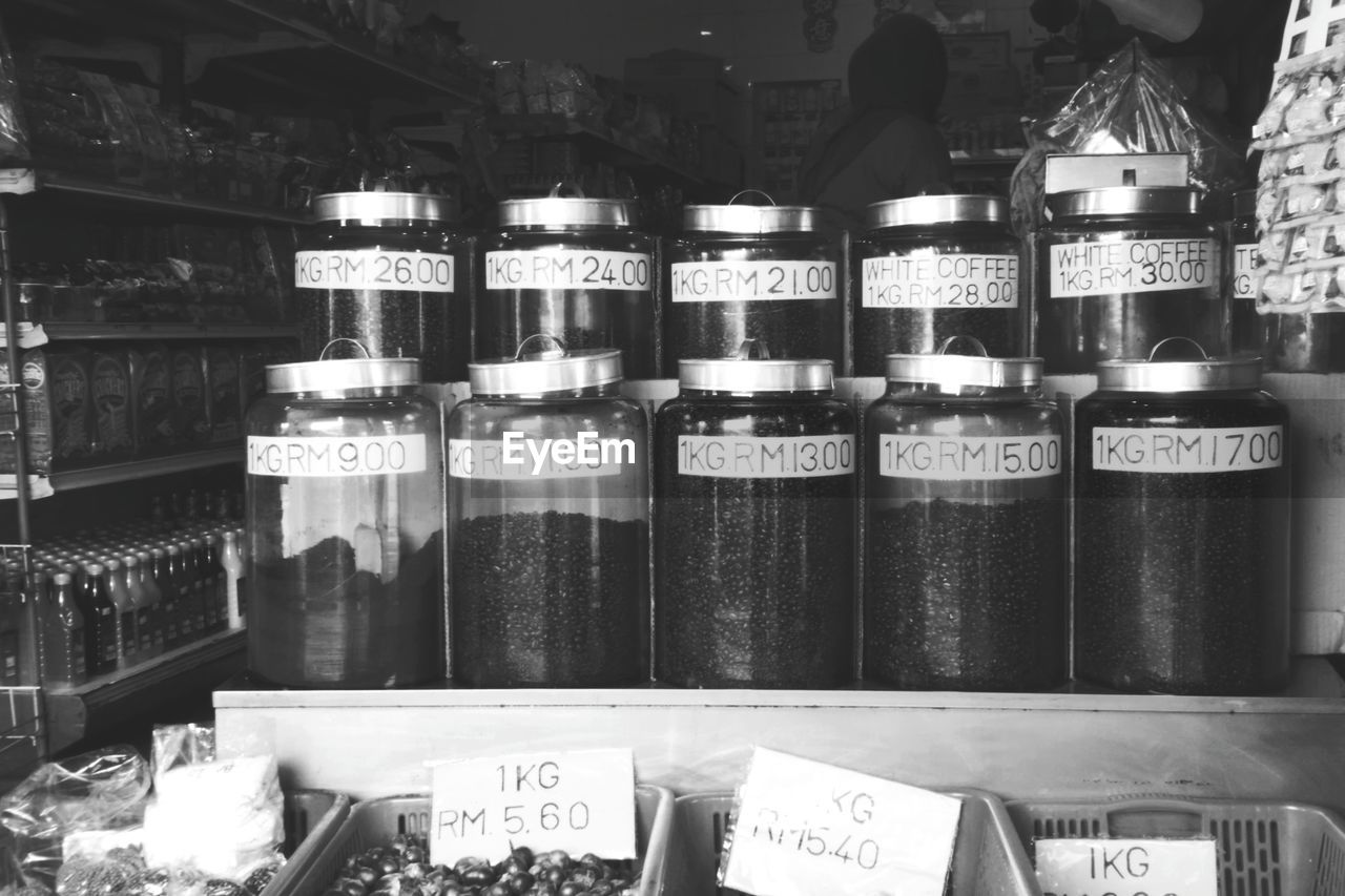 CLOSE-UP OF BOTTLES ON SHELF