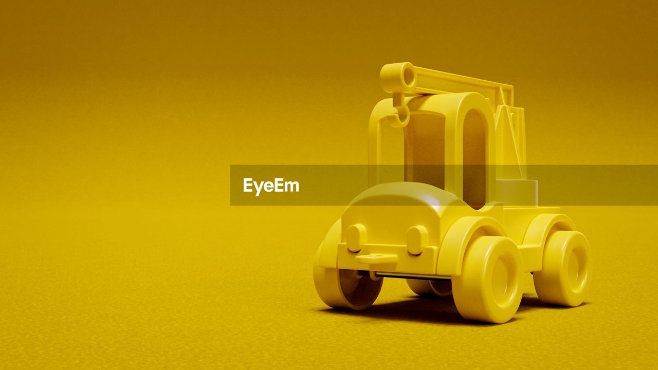 CLOSE-UP OF YELLOW TOY CAR