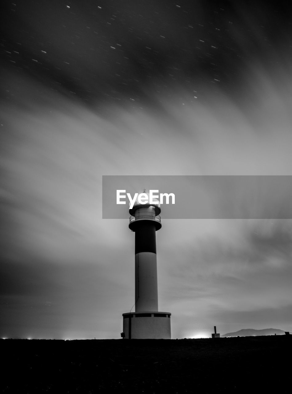 Low angle view of far del afangar lighthouse  against sky at night