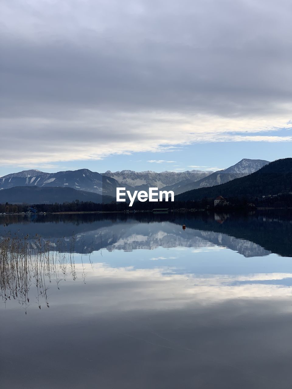 Scenic view of lake and mountains against sky