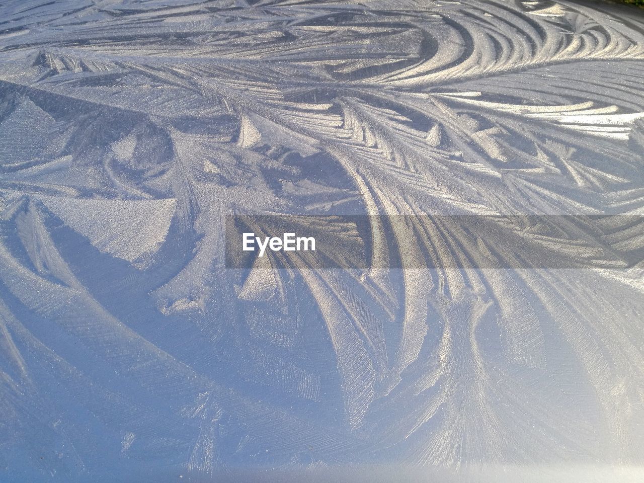 FULL FRAME SHOT OF TIRE TRACKS IN SNOW