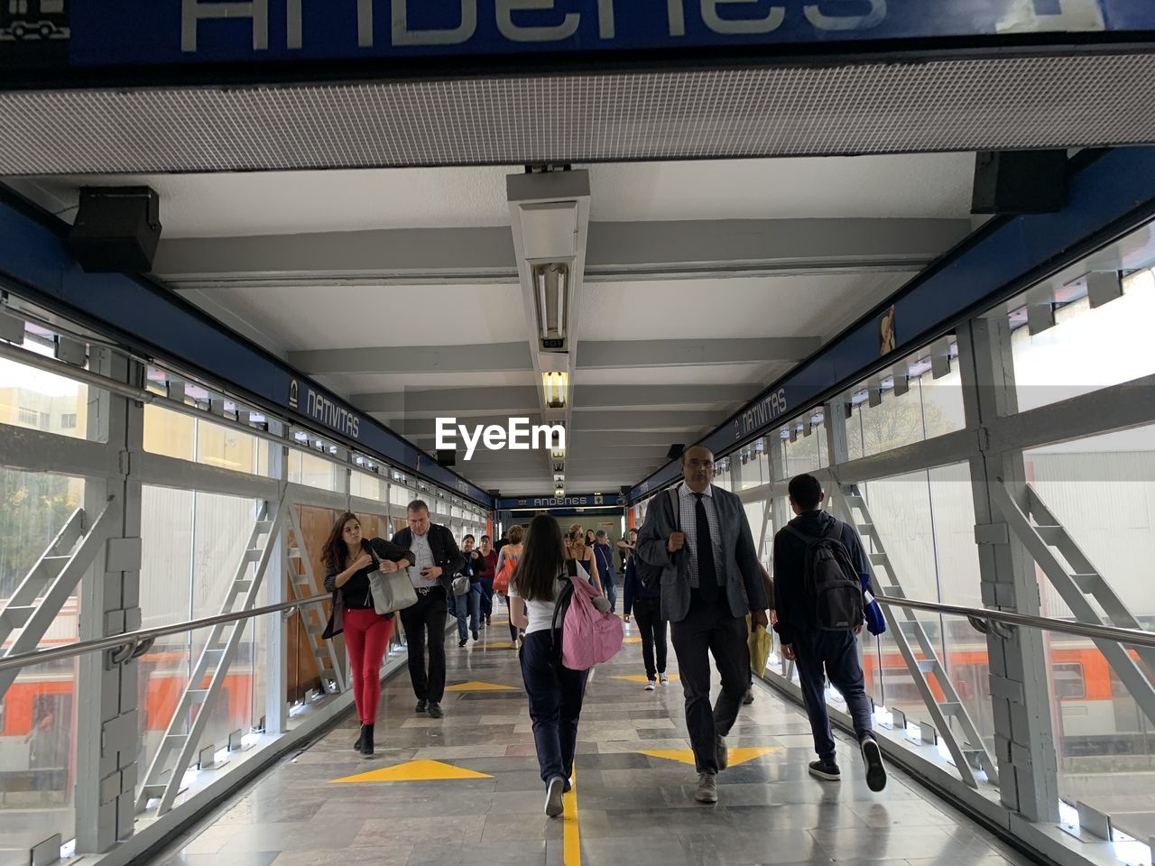 REAR VIEW OF PEOPLE WALKING IN SUBWAY