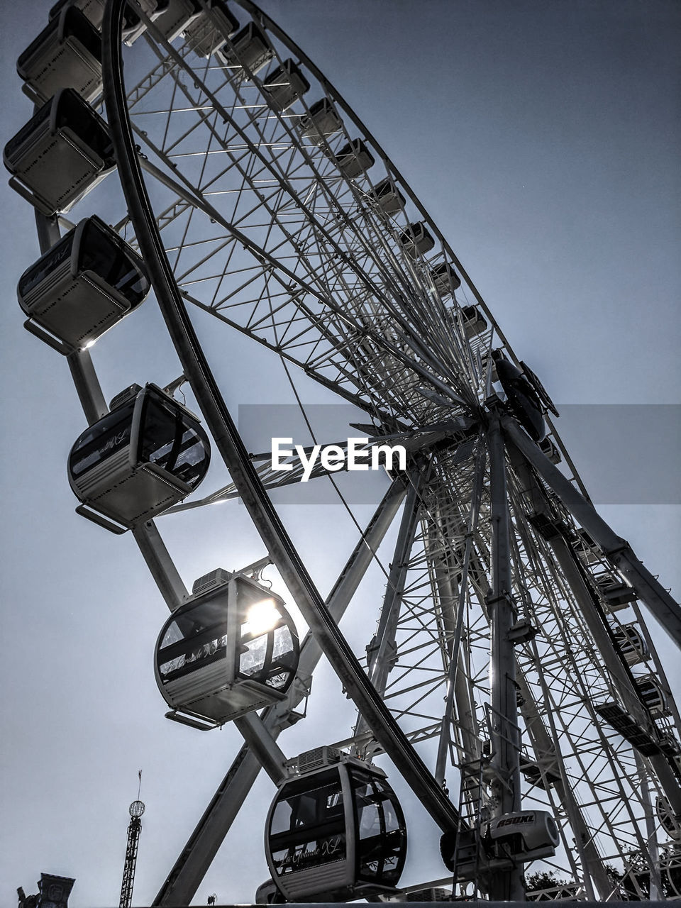 LOW ANGLE VIEW OF FERRIS WHEEL AGAINST THE SKY