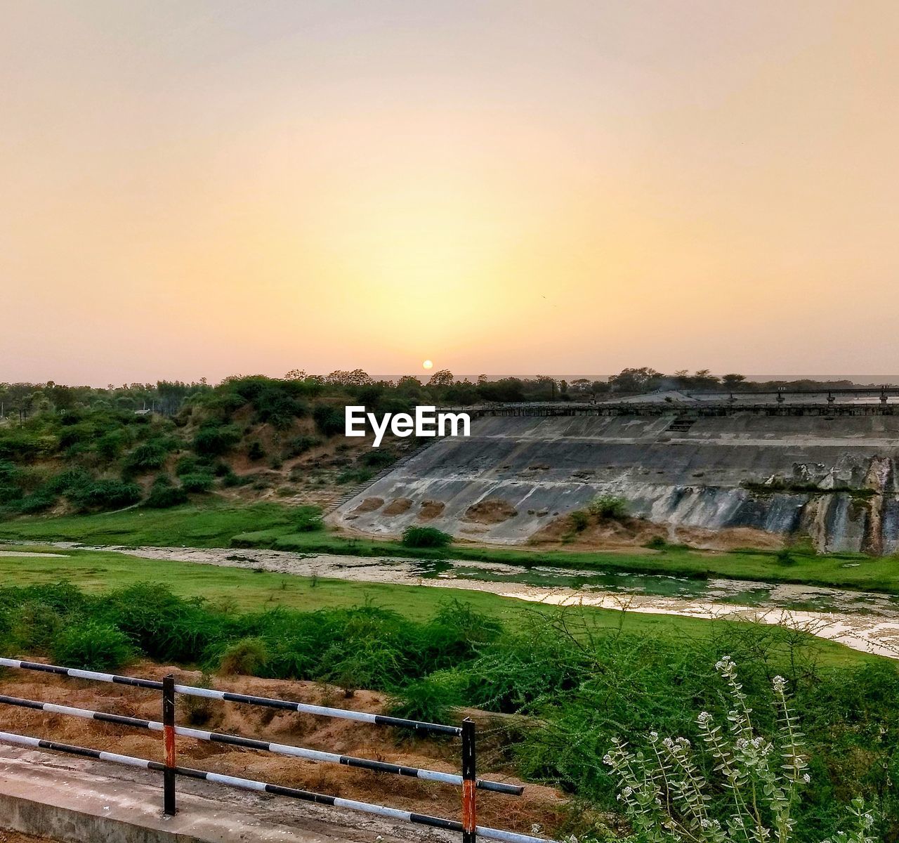 Scenic view of field against sky during sunset