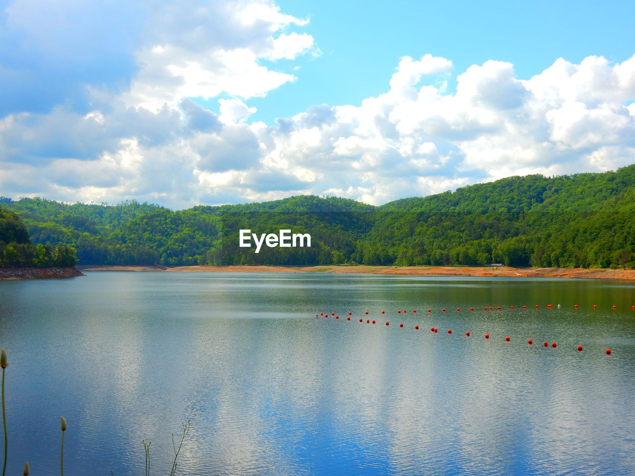 Scenic view of lake against cloudy sky