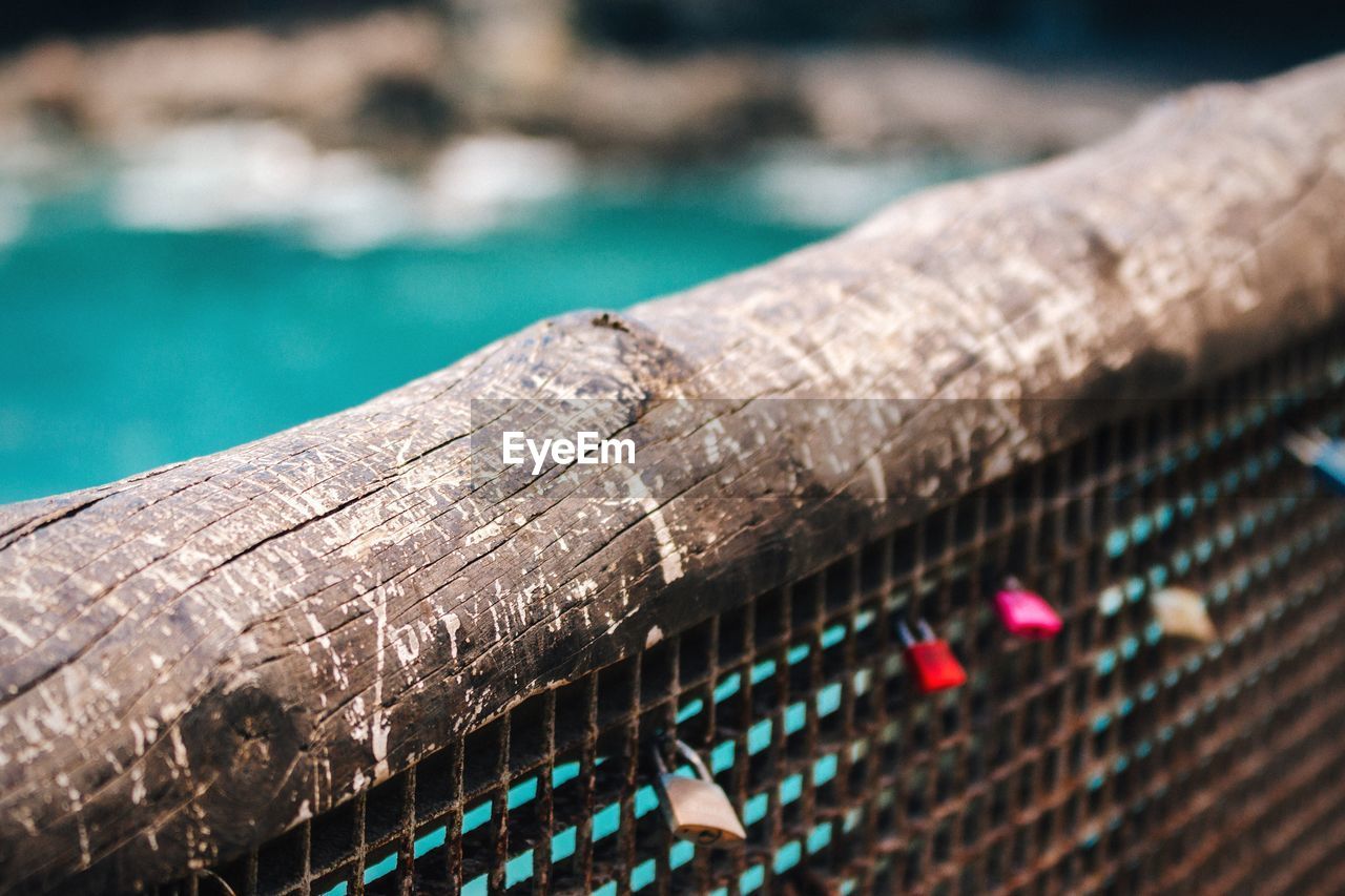 High angle view of wood on metallic fence