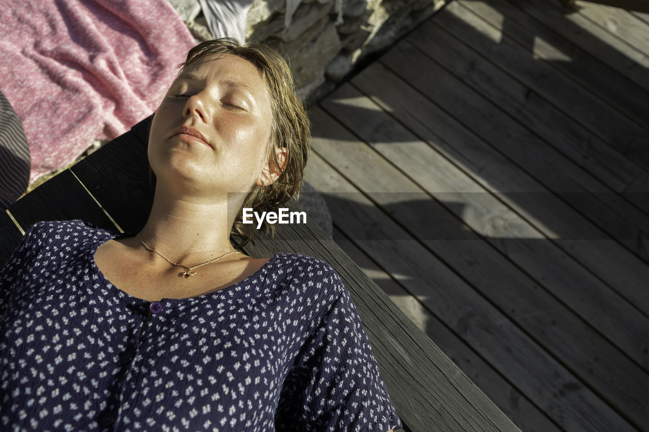 Woman sunbathing, high angle view