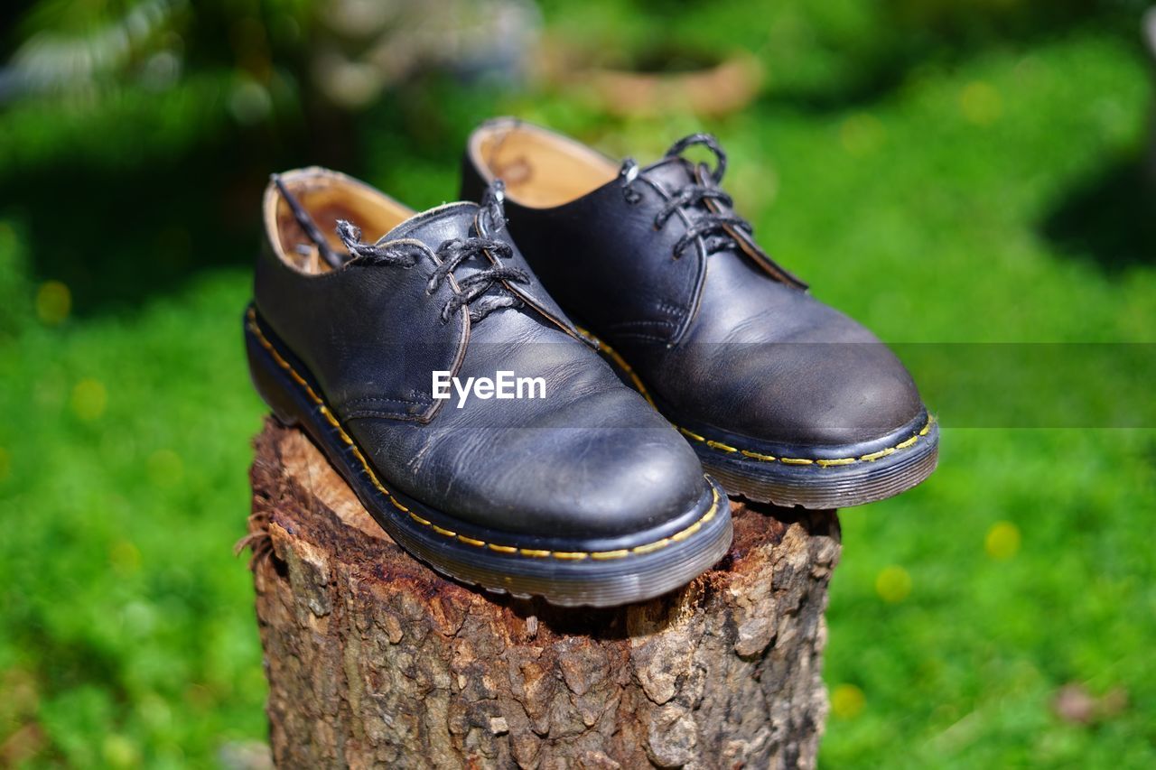 CLOSE-UP OF SHOES ON STONE