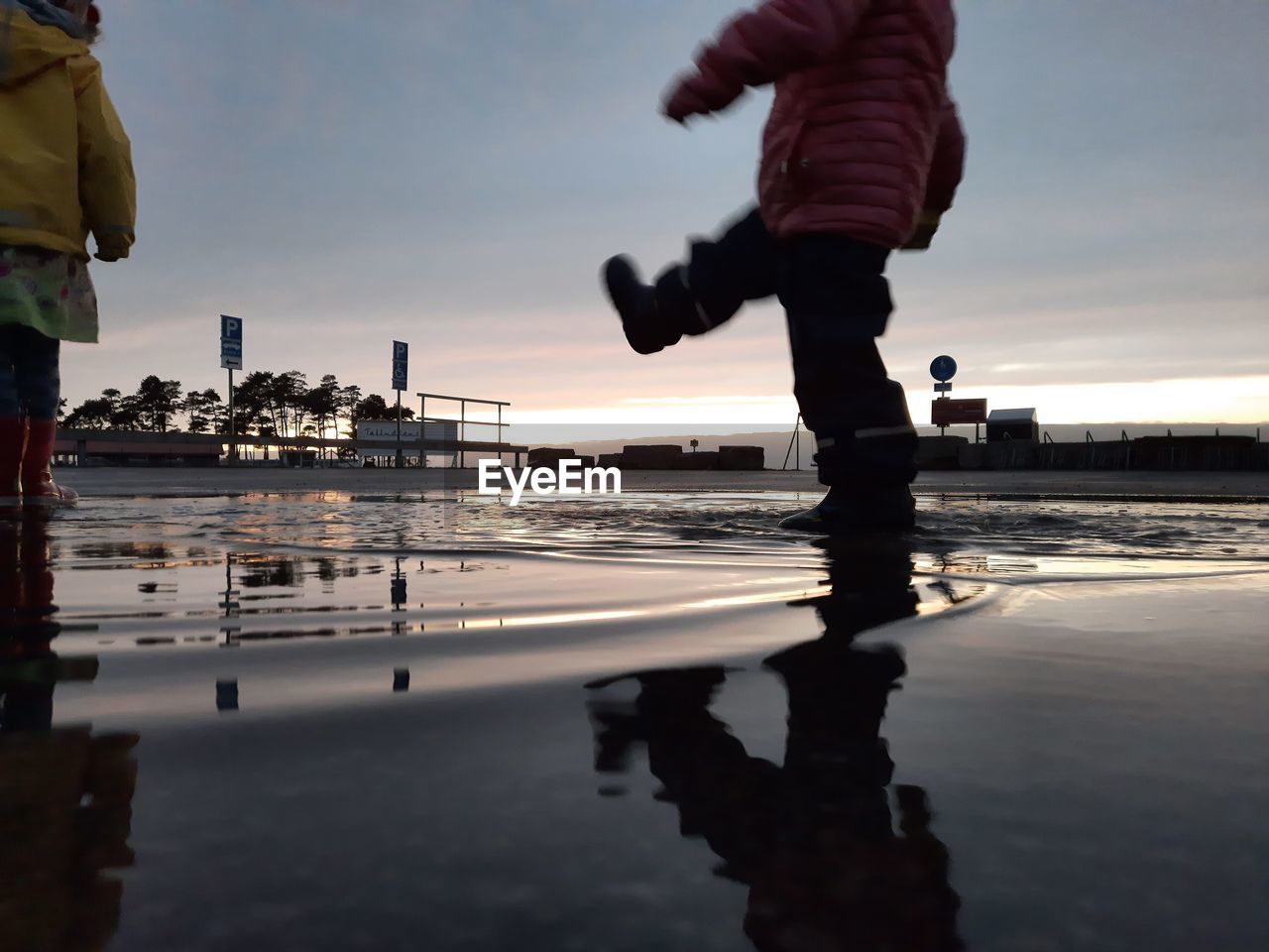 My kids walking through a puddle