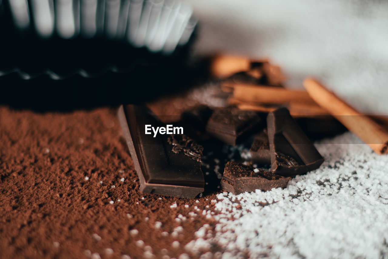 Close-up of chocolate bars and cinnamon on table