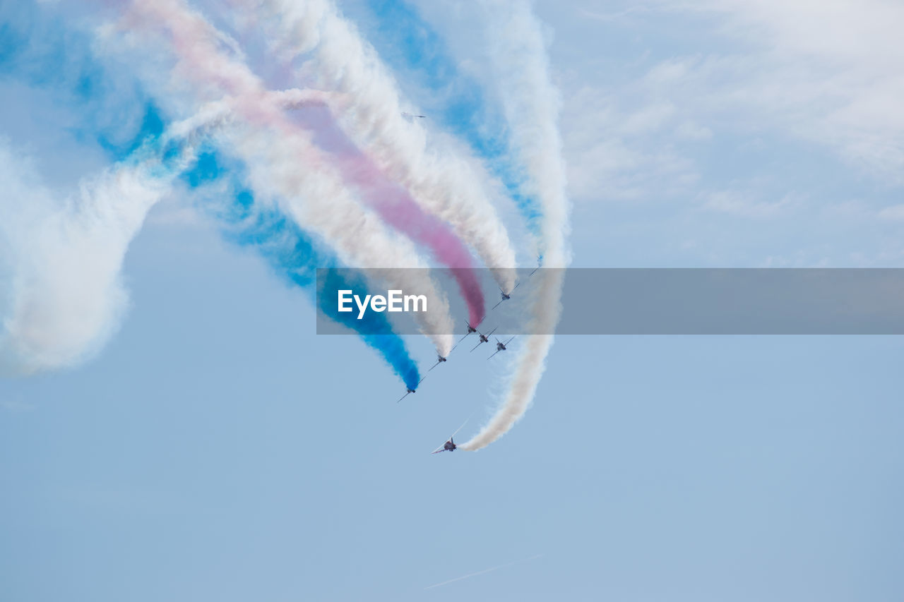 LOW ANGLE VIEW OF AIRSHOW AGAINST SKY