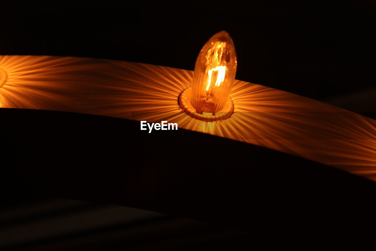 Close-up of illuminated lights at home in darkroom