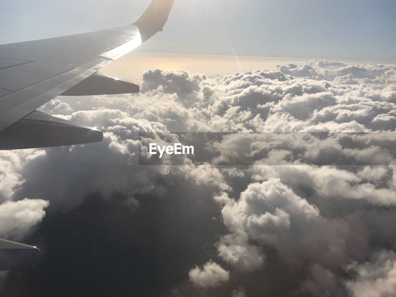 AERIAL VIEW OF CLOUDS OVER AIRPLANE WING