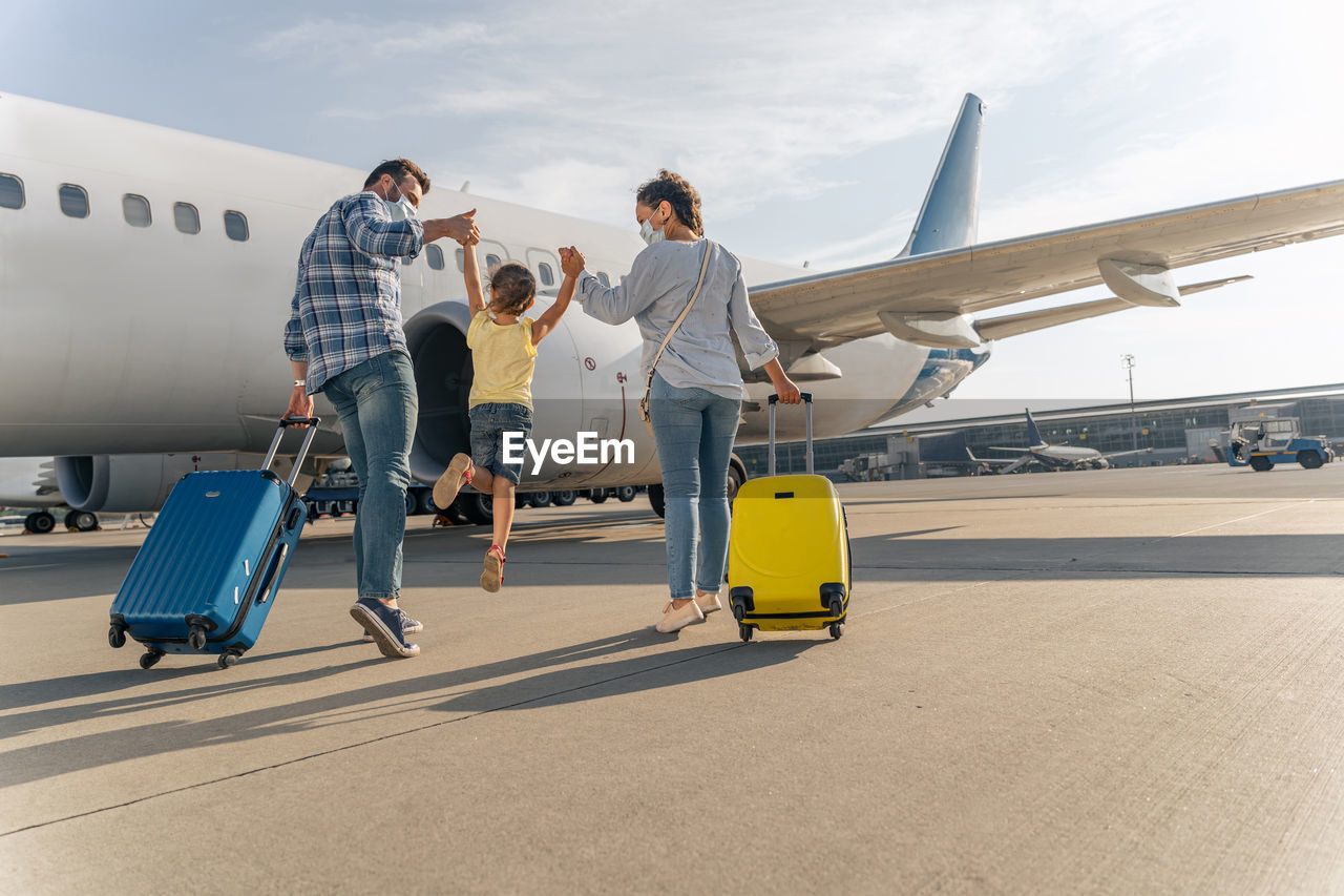 low angle view of woman standing on airport runway