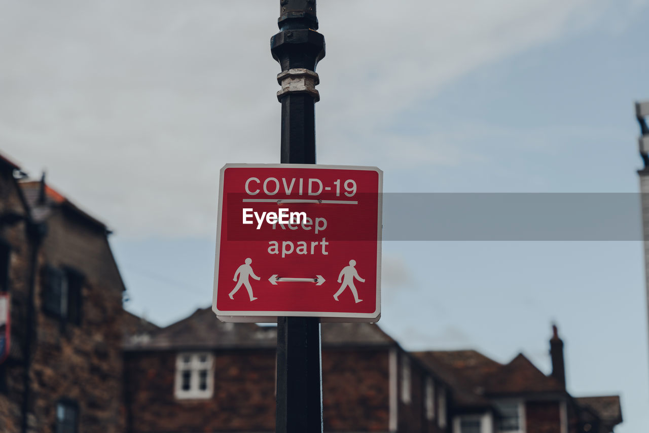 Red covid-19 keep apart sign on a sidewalk in rye, east sussex, uk, during covid 19 pandemic. 