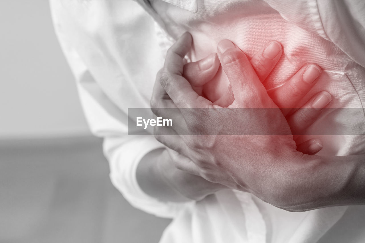 Digital composite image of man touching chest in pain