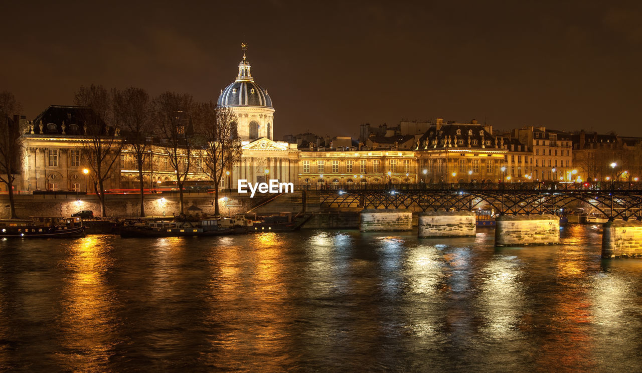 River seine with pont des arts and institut de france panorama at night in paris, france.