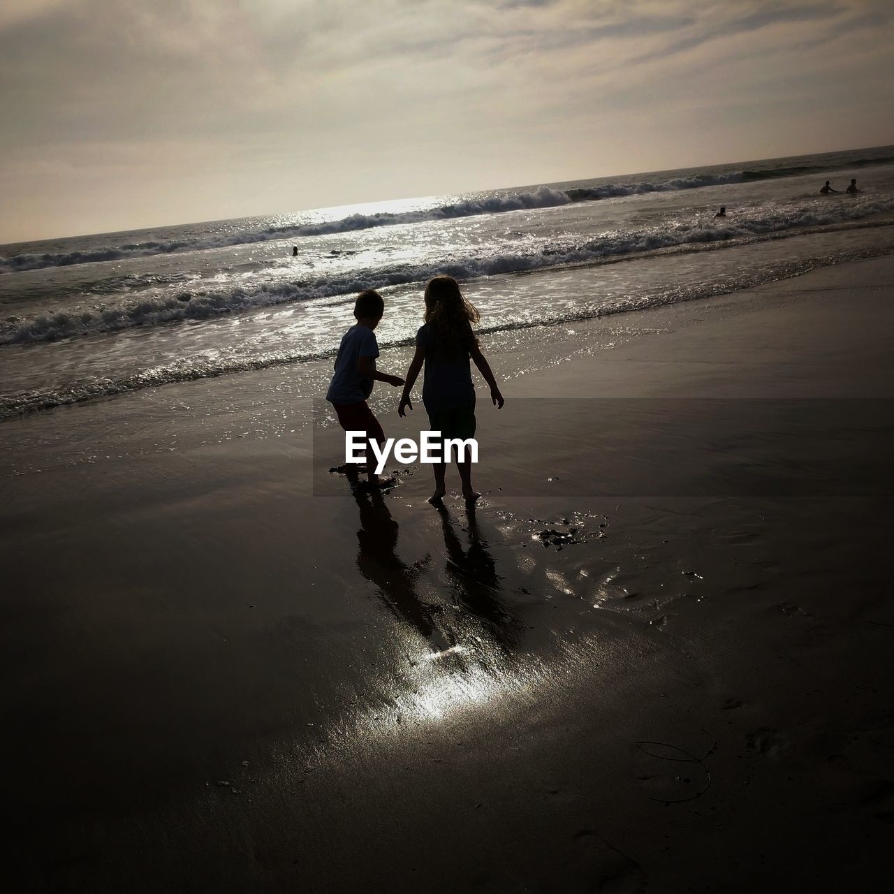 FRIENDS STANDING ON BEACH