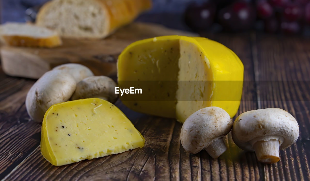 Close-up of dutch cheese with mushroom on table