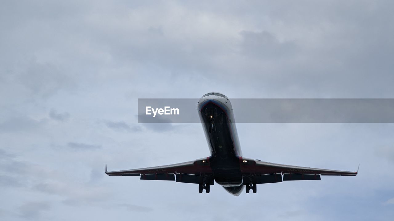low angle view of airplane flying in sky