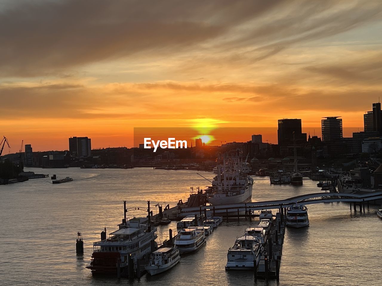 Boats in sea against sky during sunset