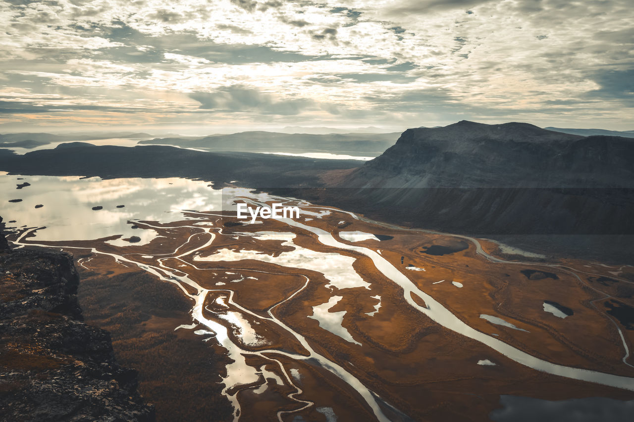 Aerial view of landscape against cloudy sky