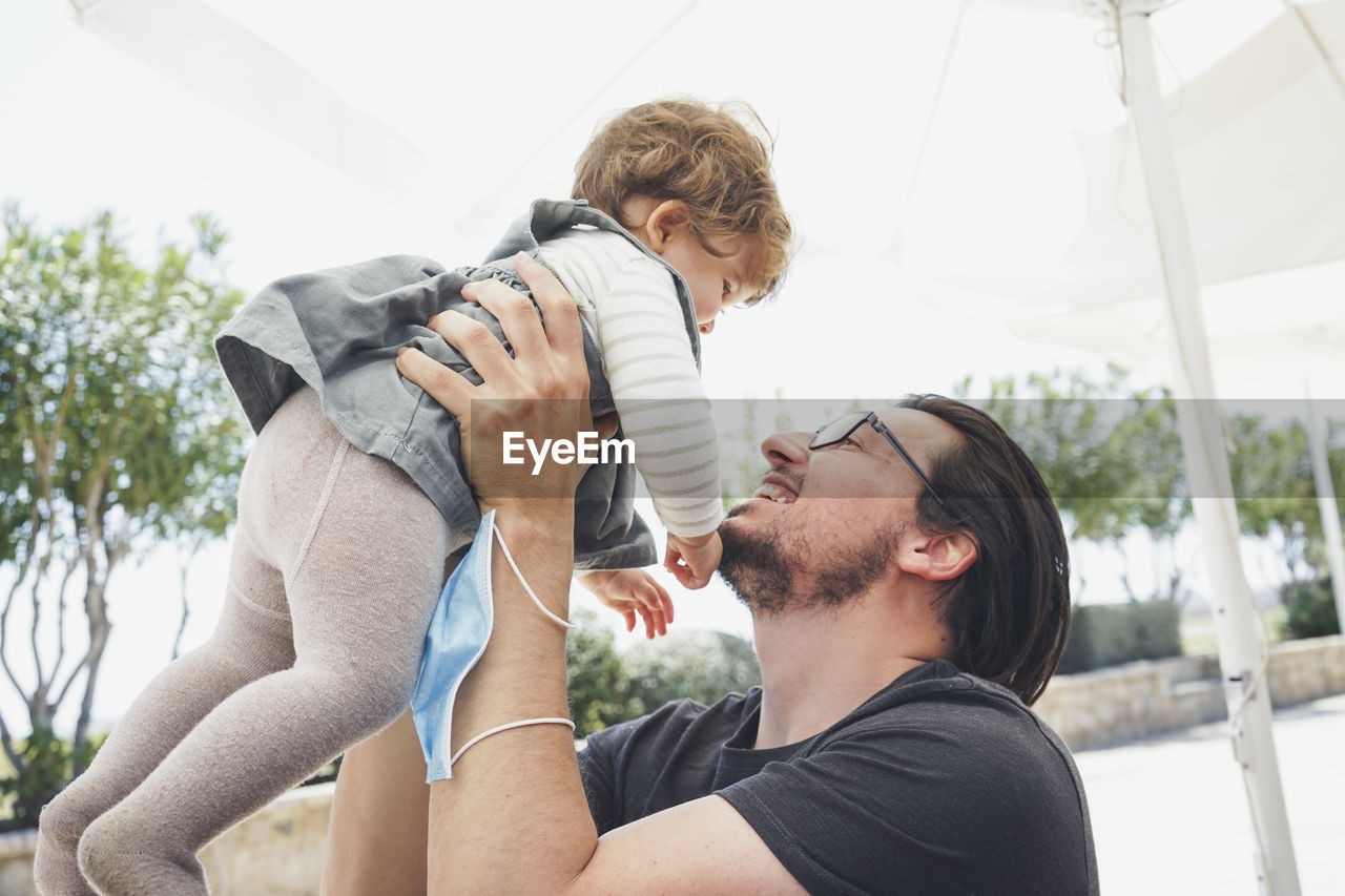 Young couple holding father