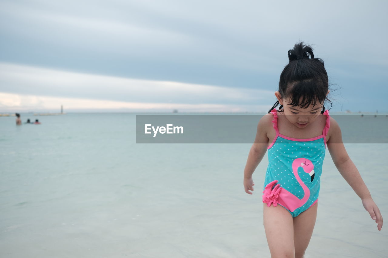 Full length of woman on beach against sky