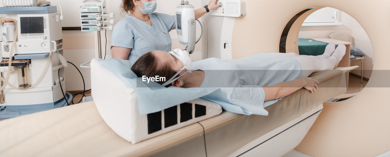 Midsection of doctor examining patient in hospital