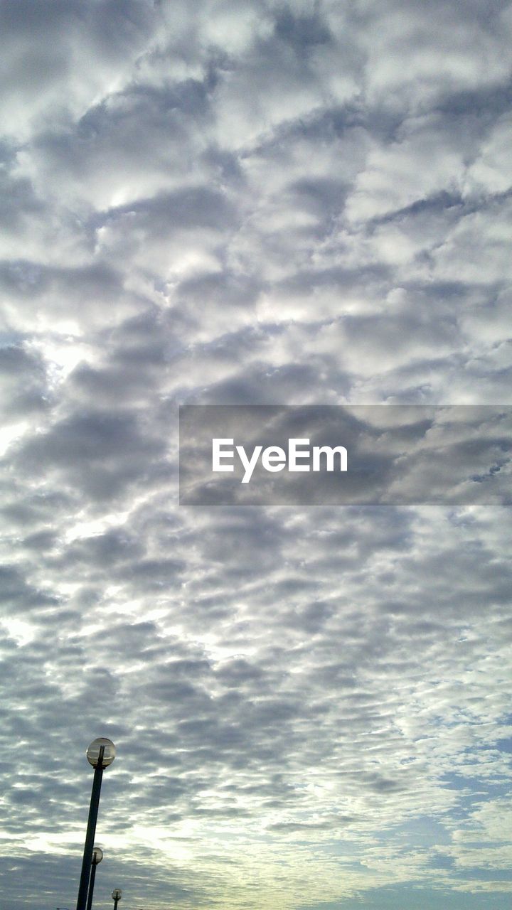 LOW ANGLE VIEW OF CLOUDY SKY OVER STREET LIGHT