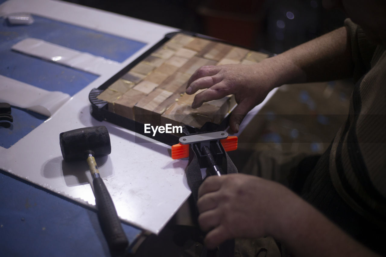 cropped hands of man working on table