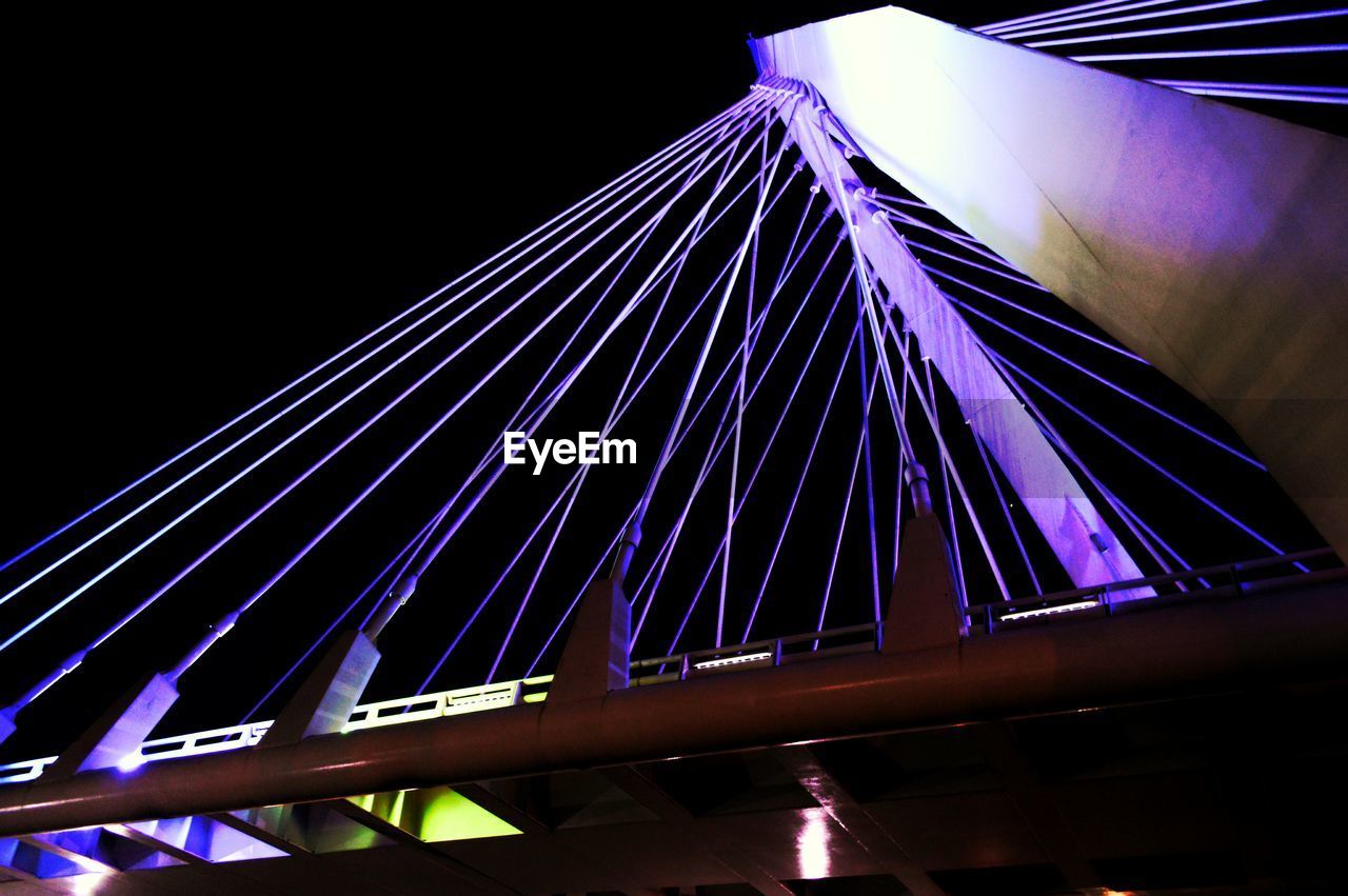 Low angle view of illuminated modern bridge