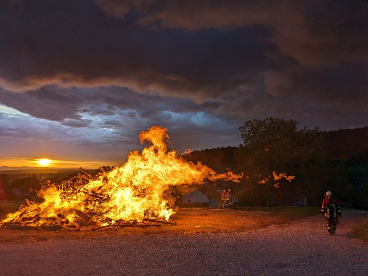 burning, fire, flame, nature, evening, sky, heat, sunset, motion, night, cloud, land, dusk, men, environment, transportation, bonfire, orange color, outdoors, adult, full length, glowing, one person