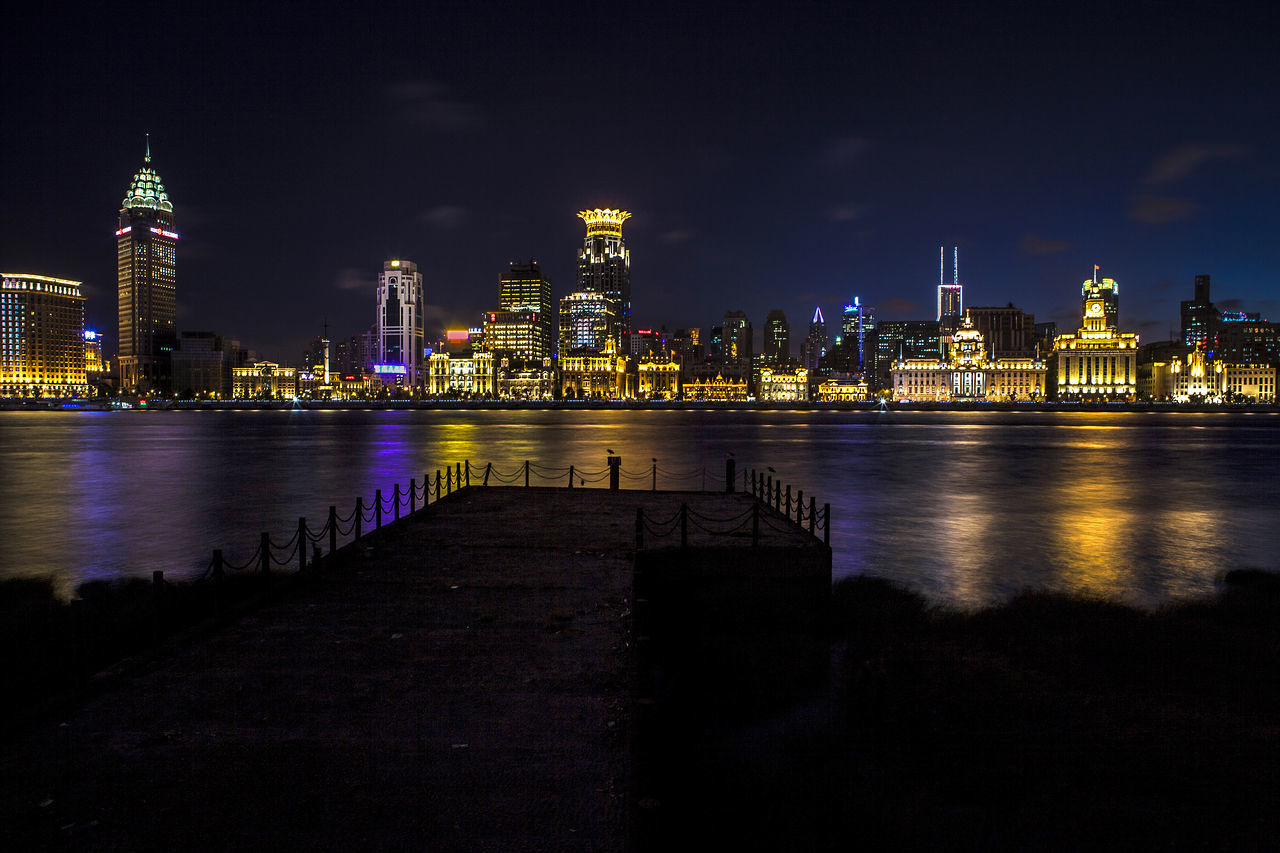 Illuminated city at waterfront