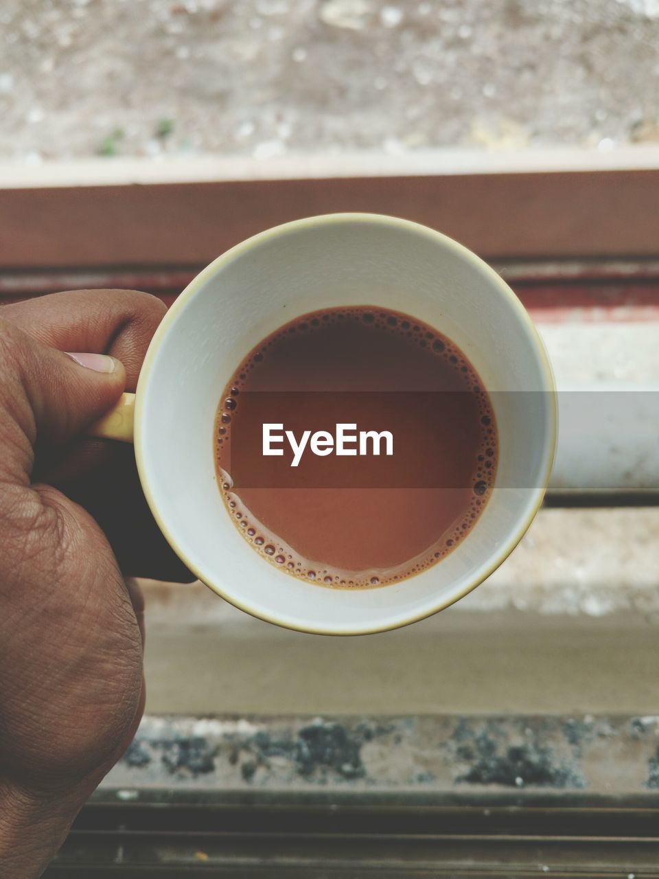 Close-up of hand holding coffee cup