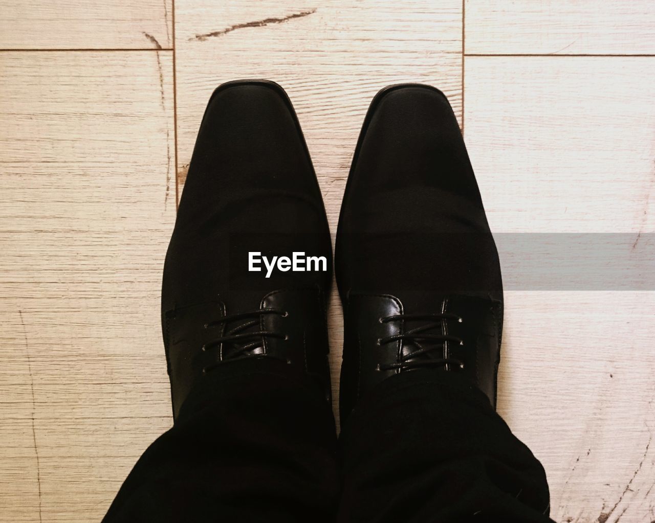 Low section of man wearing black shoes