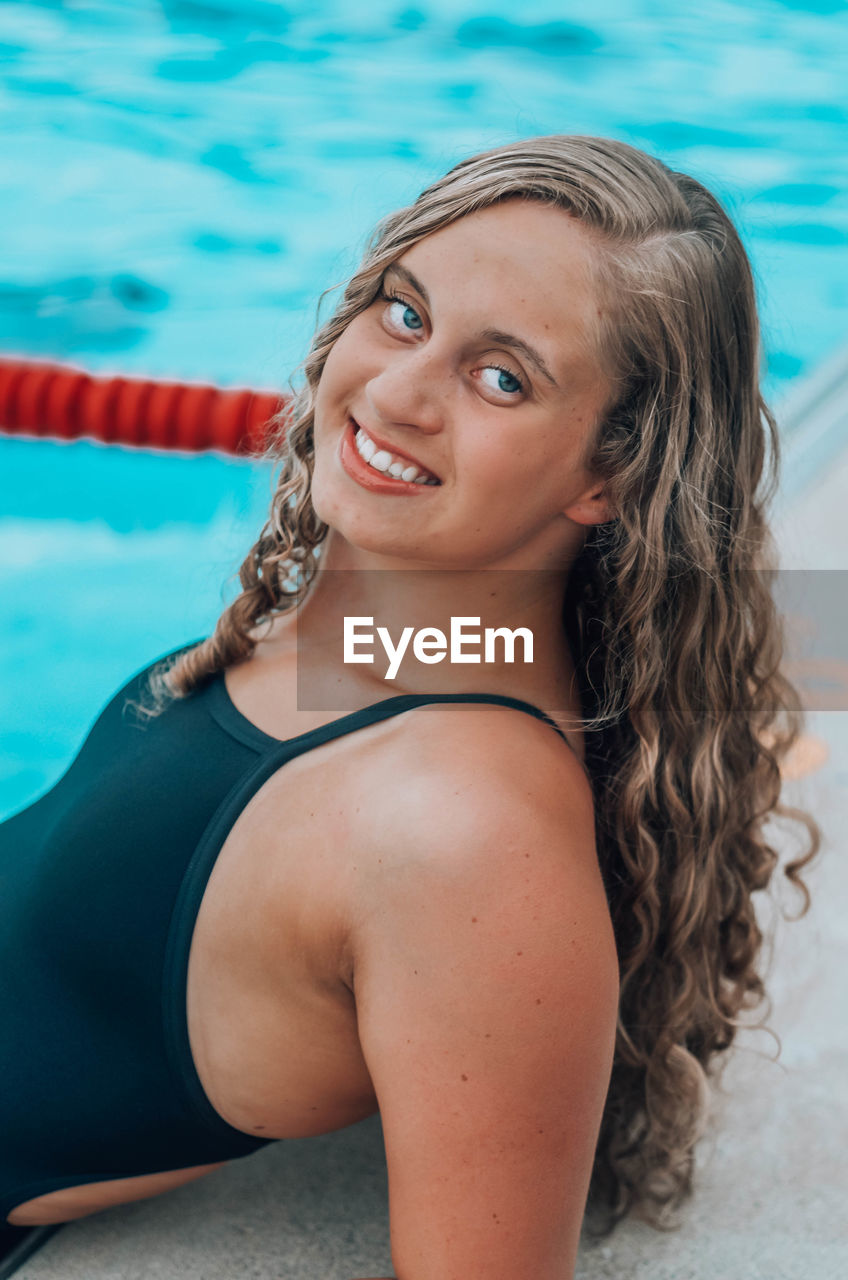 Portrait of smiling young woman in swimming in pool