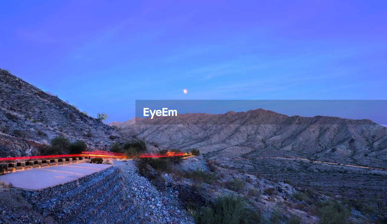 Scenic view of mountains against clear blue sky